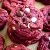 Stack of red velvet cookies with more cookies around it