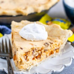 One slice of easy butterfinger pie with a dollop of whipped cream