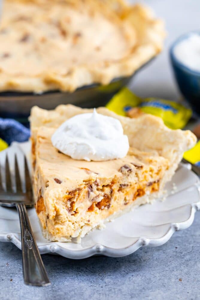One slice of easy butterfinger pie with a dollop of whipped cream