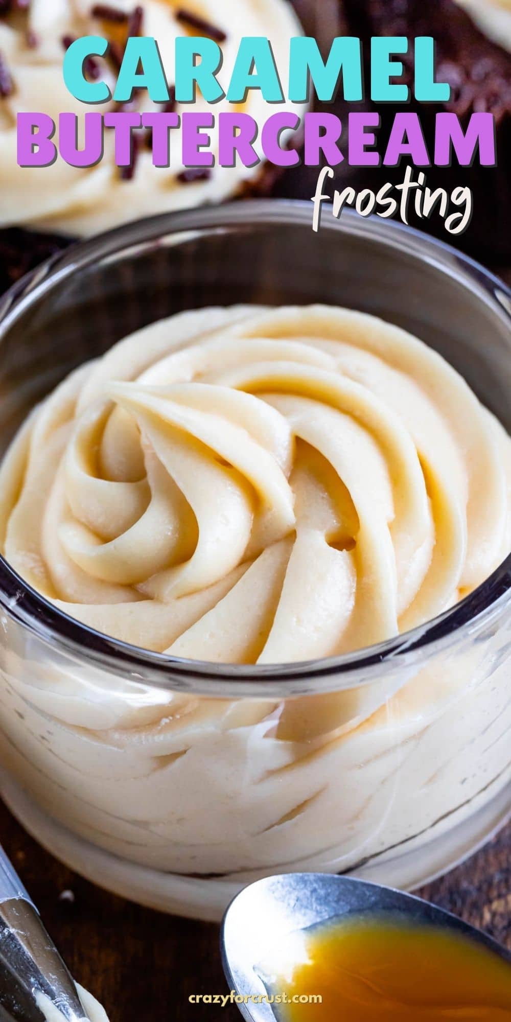 frosting in jar with caramel on spoon and piping bag in front and cupcakes behind