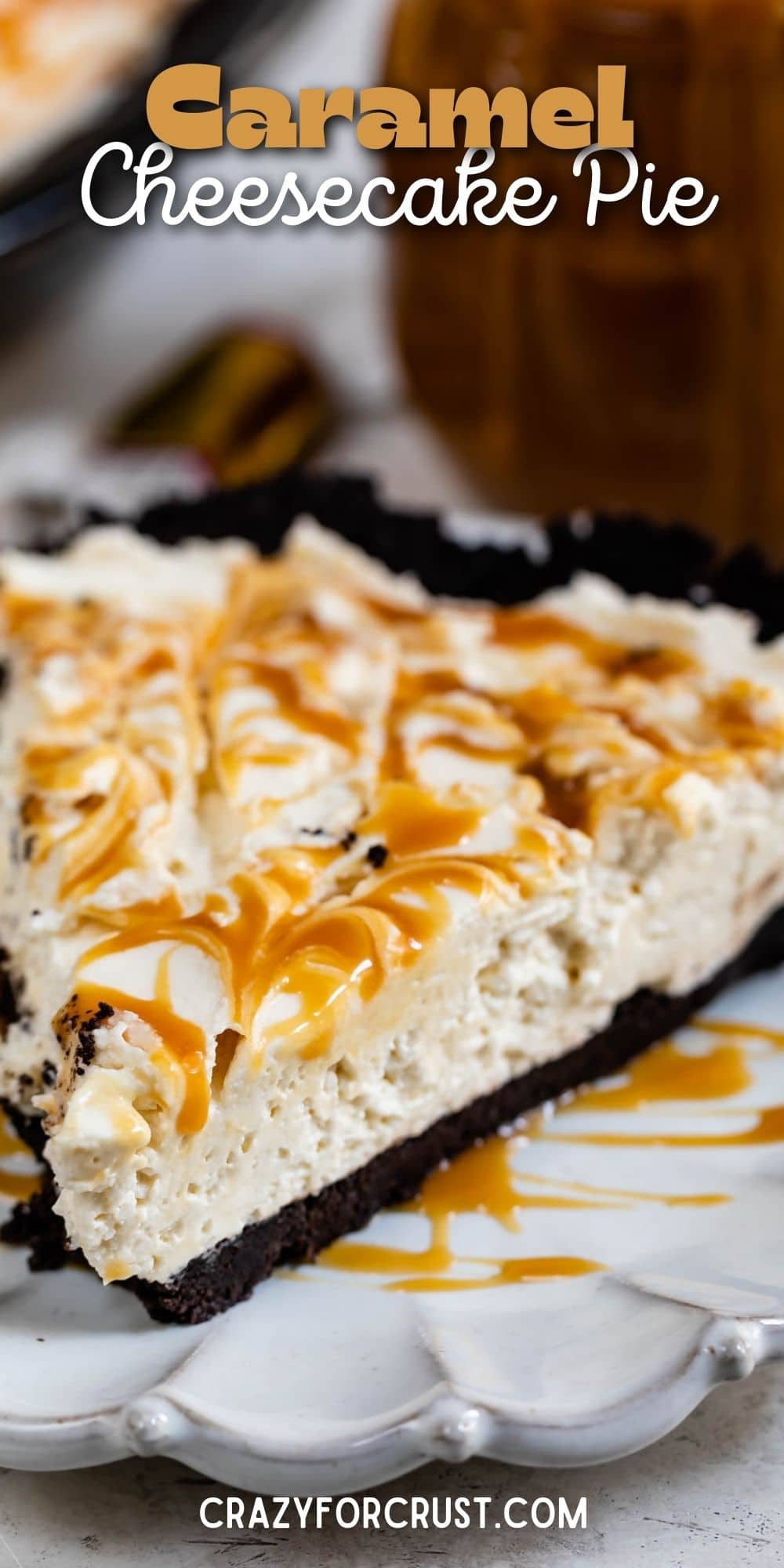 Close up shot of a slice of caramel cheesecake pie on a white scalloped plate with recipe title on top of image