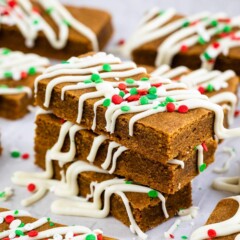 Three gingerbread cookie bars decorated for the holidays and stacked on top of eachother