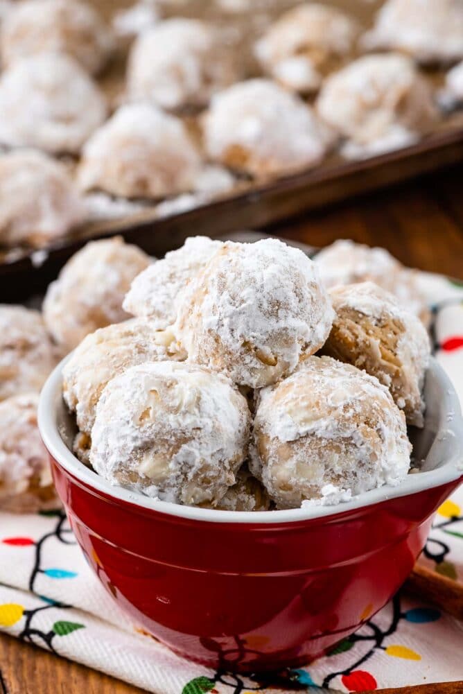 Red bowl full of gingerbread snowball cookies