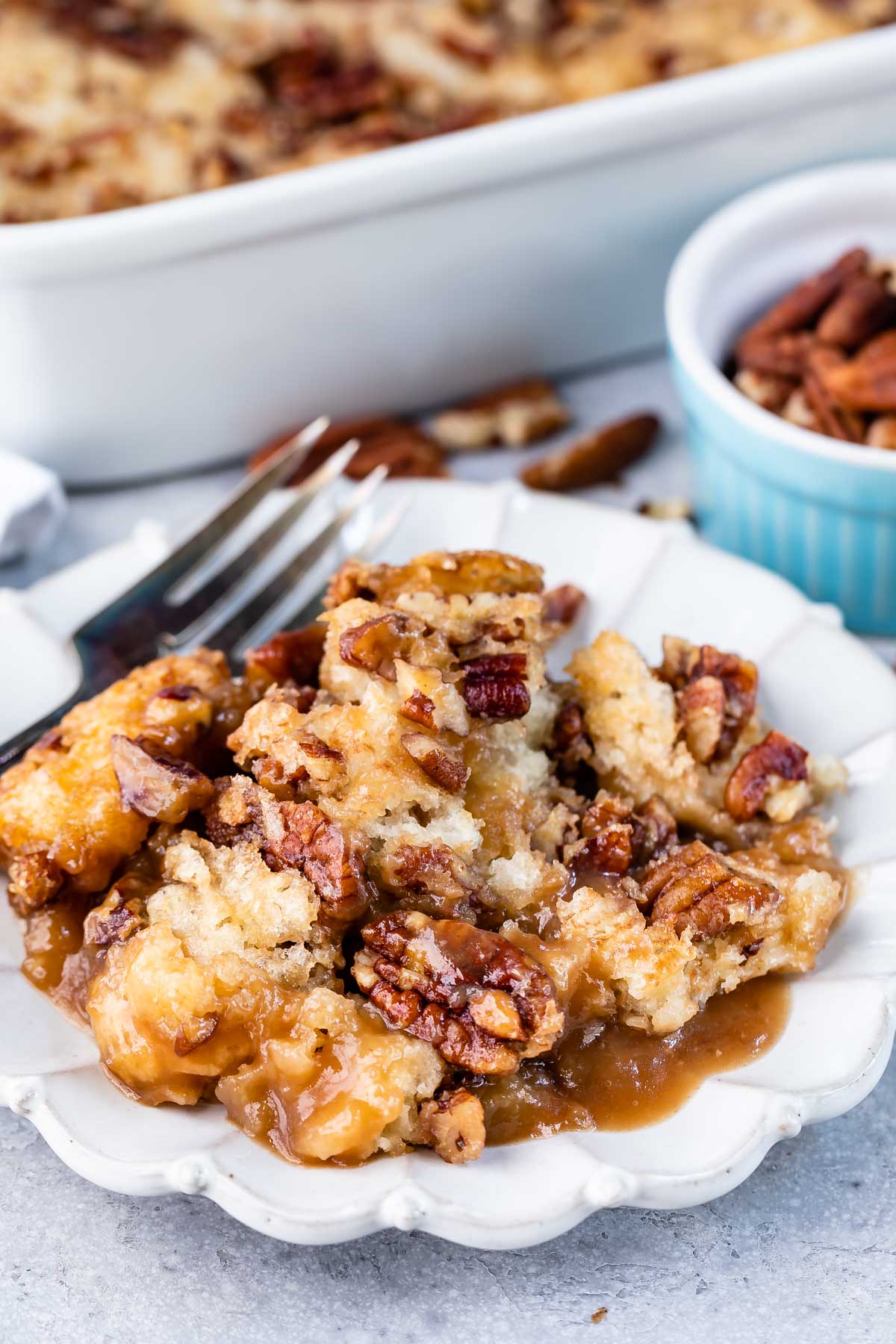 Pecan pie cobbler on a white scalloped dish