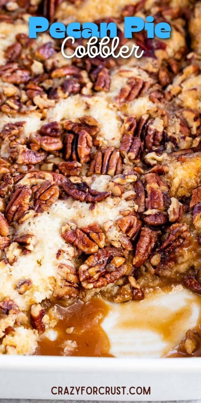 Pecan pie cobbler in a white baking dish with corner piece missing with recipe title on top of image