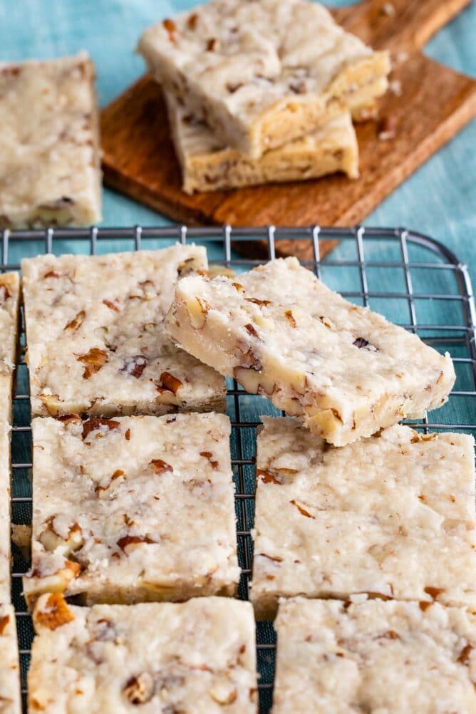 Pecan shortbread cookies cut into squares on a metal cooling rack