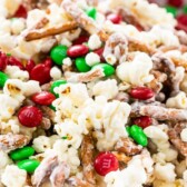 Bowl of santa munch popcorn snack mix with recipe title on top of image