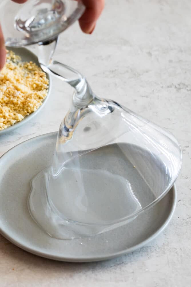 glass dipping in corn syrup on gray plate