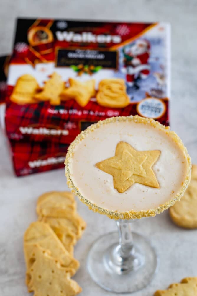 glass with martini and star cookie with walkers shortbread boxes behind