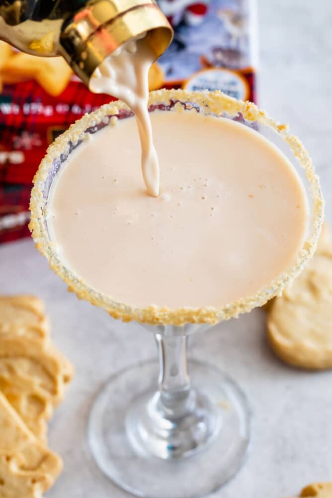 pouring martini in glass with cookie rim