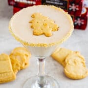 martini glass full with christmas tree shaped shortbread cookie floating on top