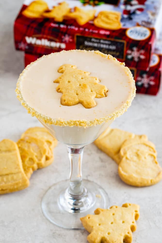 martini glass full with christmas tree shaped shortbread cookie floating on top