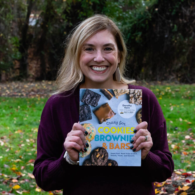 woman holding cookbook in park