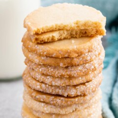 Tall stack of easy butter cookies with top two cookies split in half