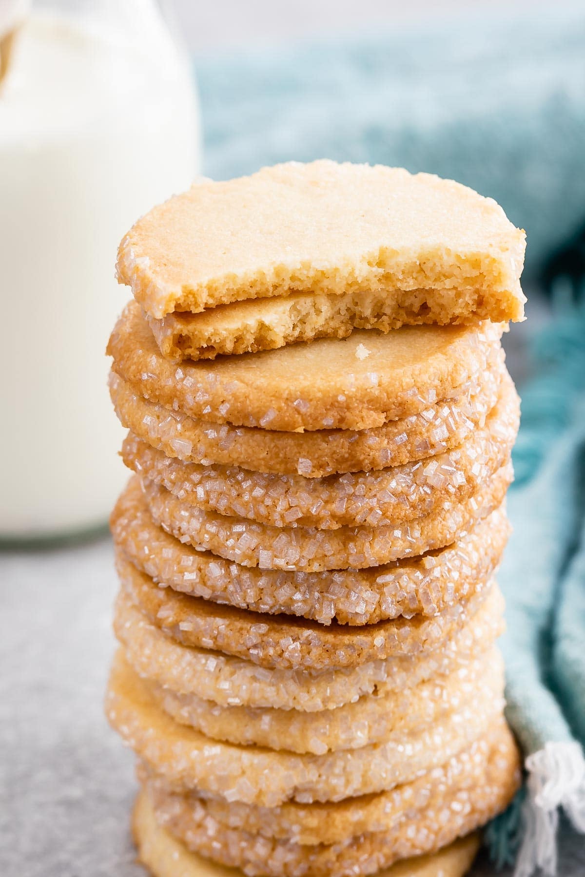 Tall stack of easy butter cookies with top two cookies split in half