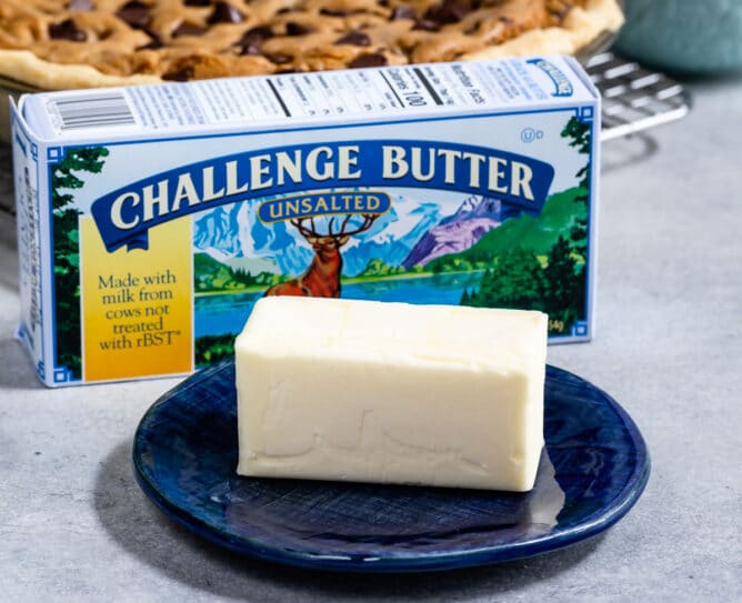 stick of butter on blue plate with challenge butter box behind