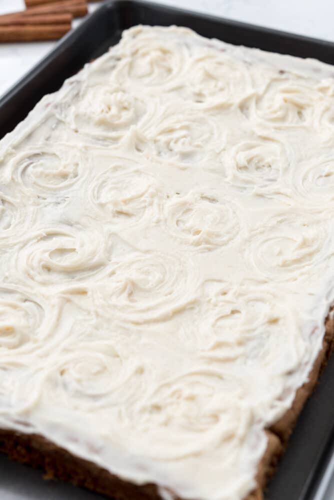 Full sheet pan of cinnamon roll blondies with icing on top