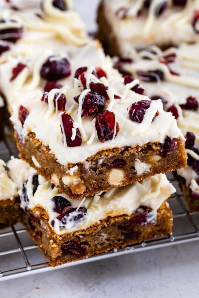 Two cranberry bliss bars stacked on top of eachother