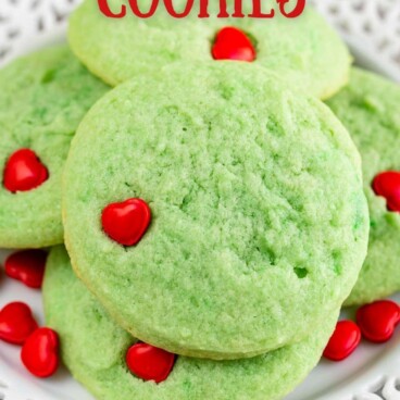 Close up photo of large stack of grinch cookies on a white plate