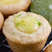 Close up of mini lime tarts with the recipe title on top of image