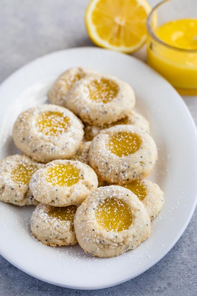 stack of lemon thumbprint cookies on white plate