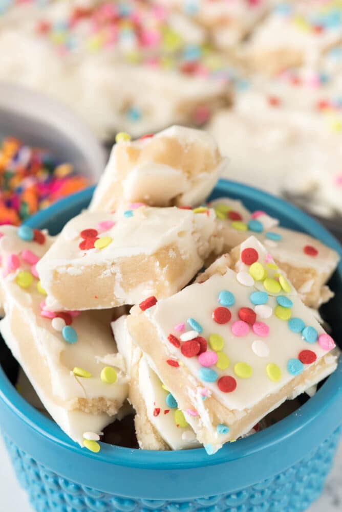 Bowl full of sugar cookie bark topped with confetti rainbow sprinkles