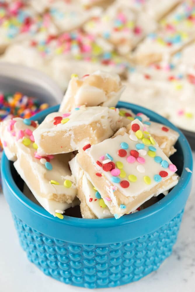 Bowl full of sugar cookie bark topped with confetti rainbow sprinkles