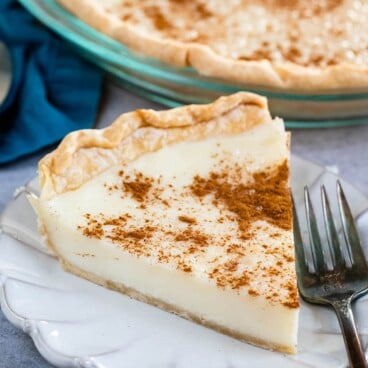 One slice of sugar cream pie on a plate with fork