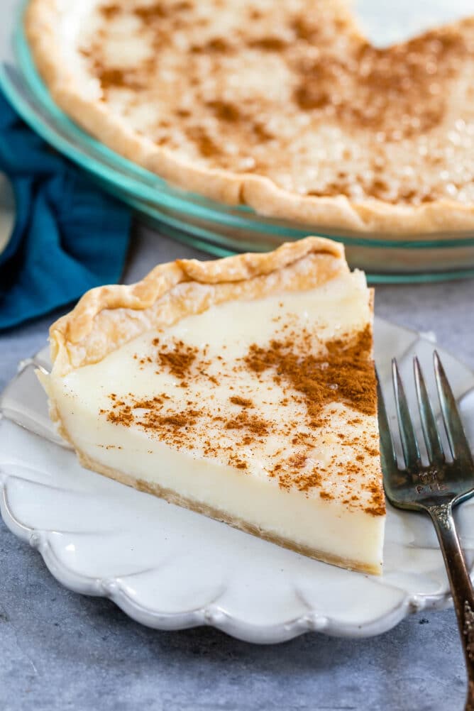 One slice of sugar cream pie on a plate with fork