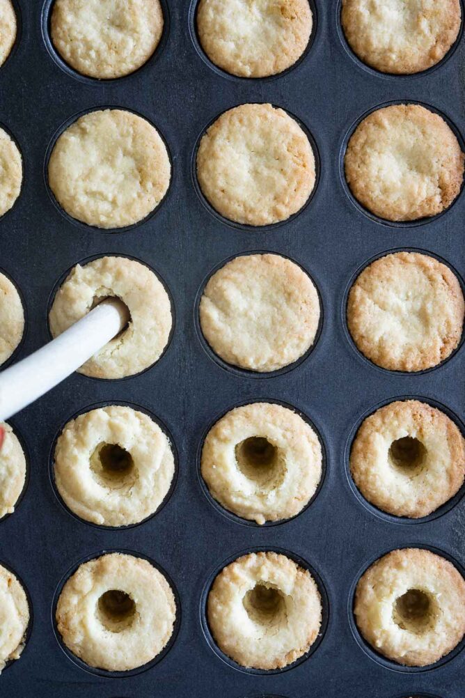 Overhead shot showing holes being poked in the middle of the mini tarts