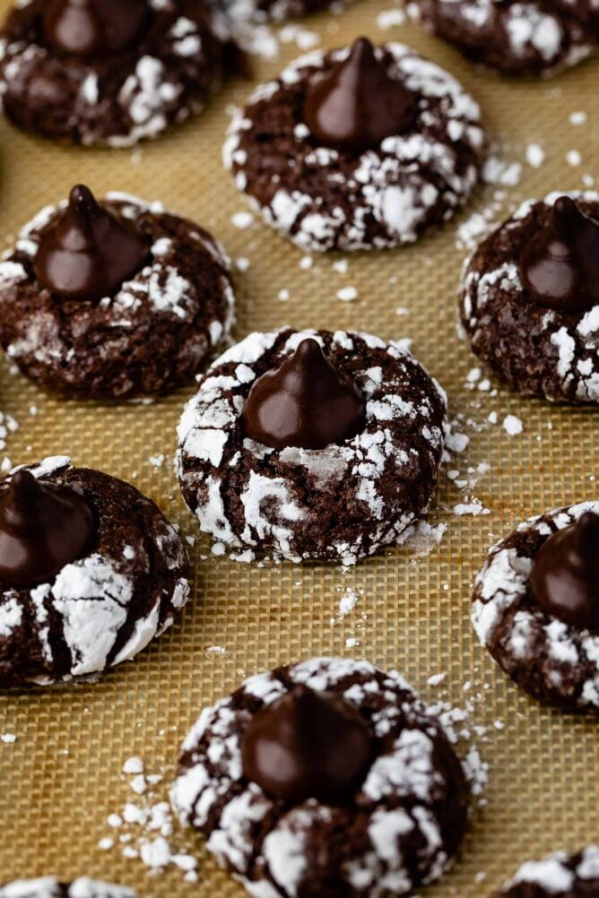 Overhead view of chocolate mint kiss crinkles on a silicon baking mat