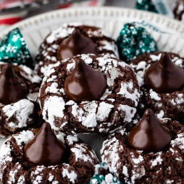 Plate full of chocolate mint kiss crinkle cookies with hershey kisses