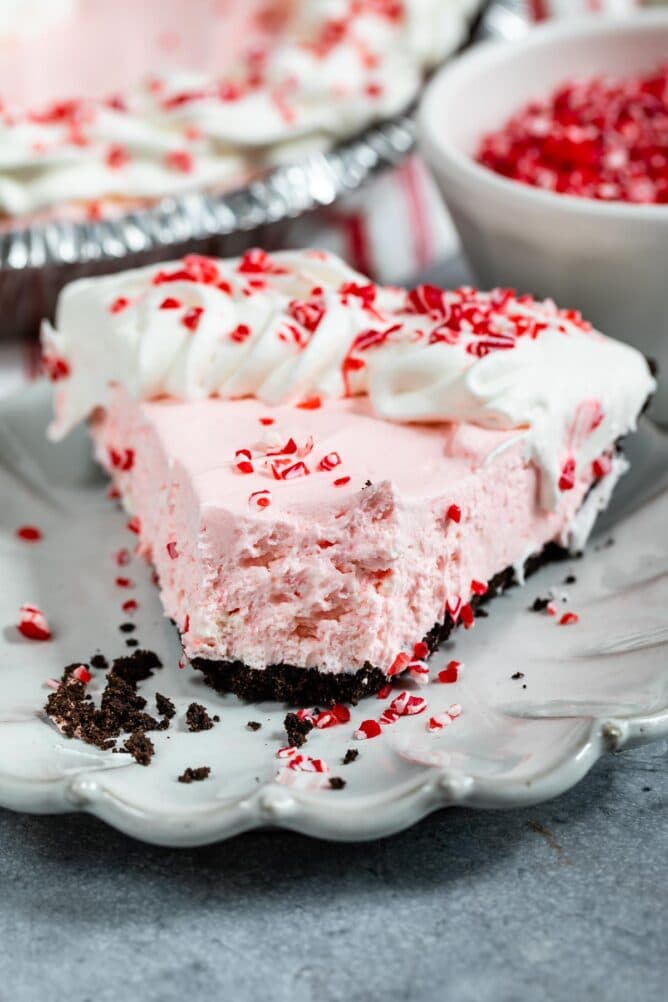 Close up shot of a slice of peppermint pie with one bite missing