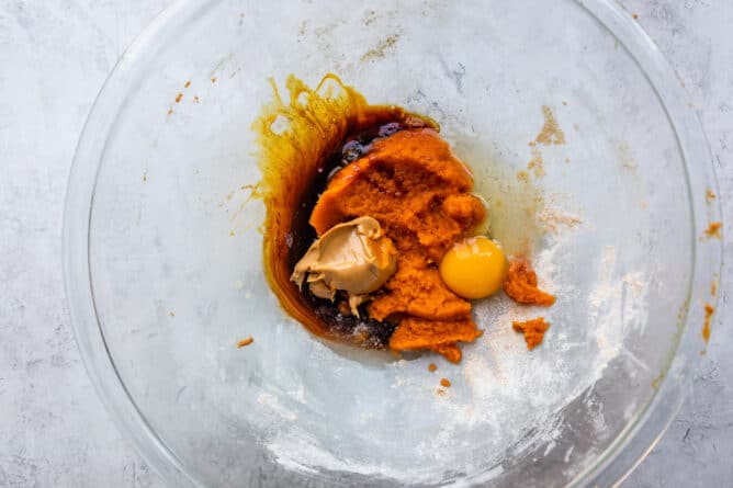 Overhead shot of wet ingredients being mixed in glass bowl