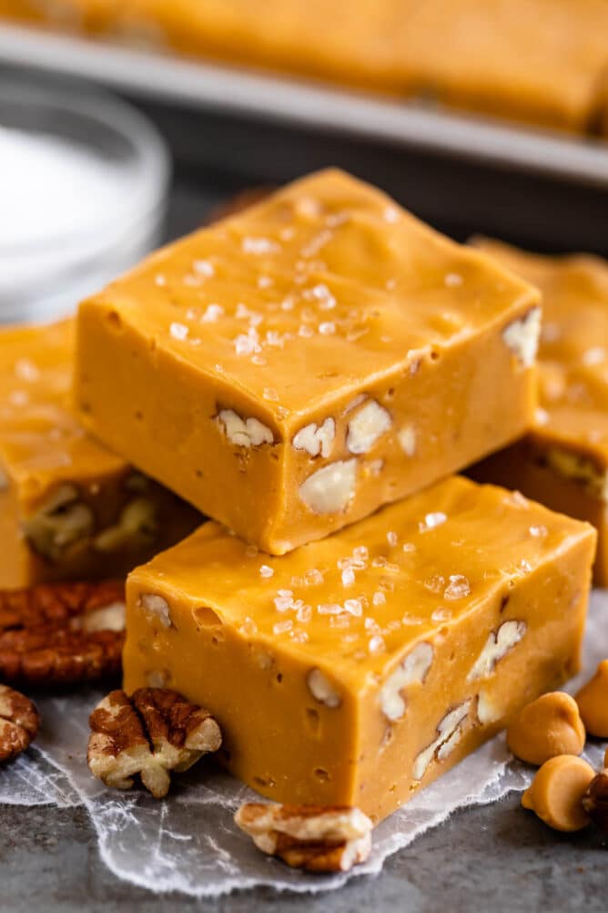 Two pieces of salted butterscotch fudge stacked on top of eachother