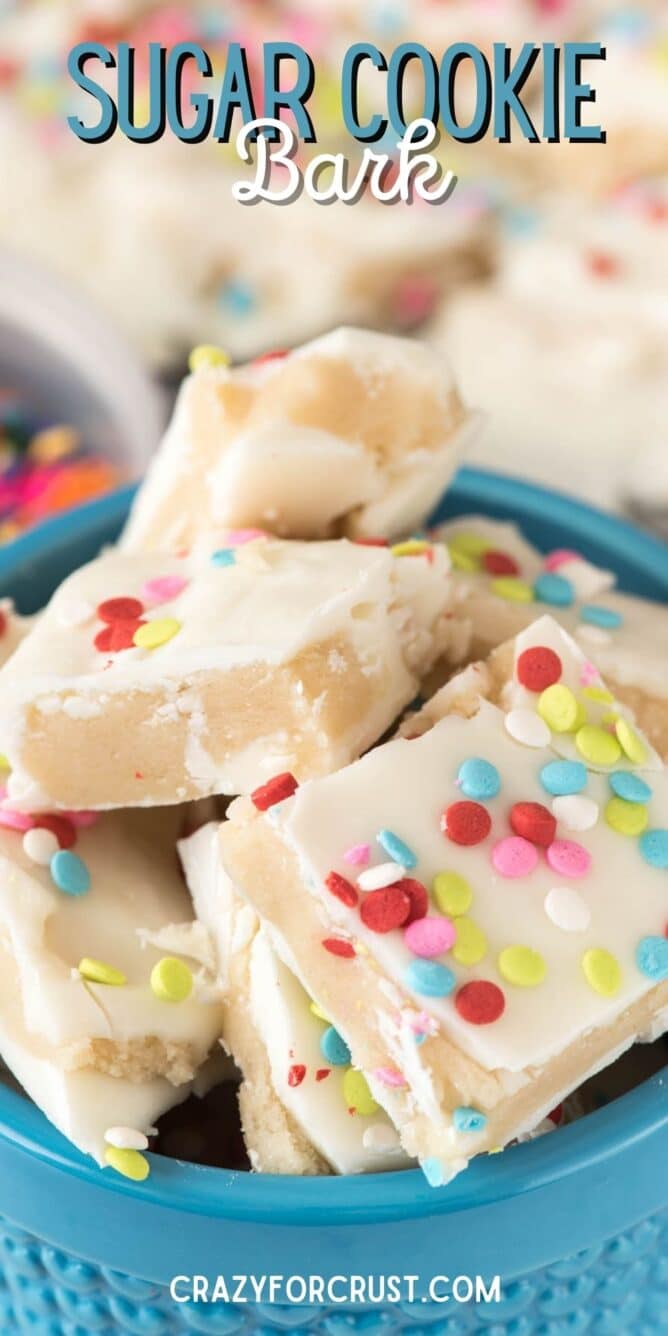 Bowl full of sugar cookie bark topped with confetti rainbow sprinkles and recipe title on top of image