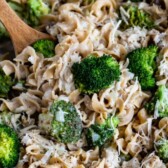 Overhead shot of chicken broccoli skillet in pan with recipe title on top of image
