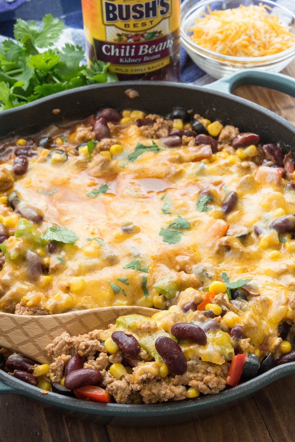 Overhead shot of one pot taco casserole in dish with wooden spoon