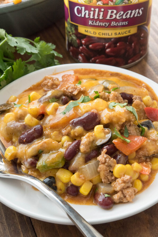 Plate full of one pot taco casserole with can of beans in background