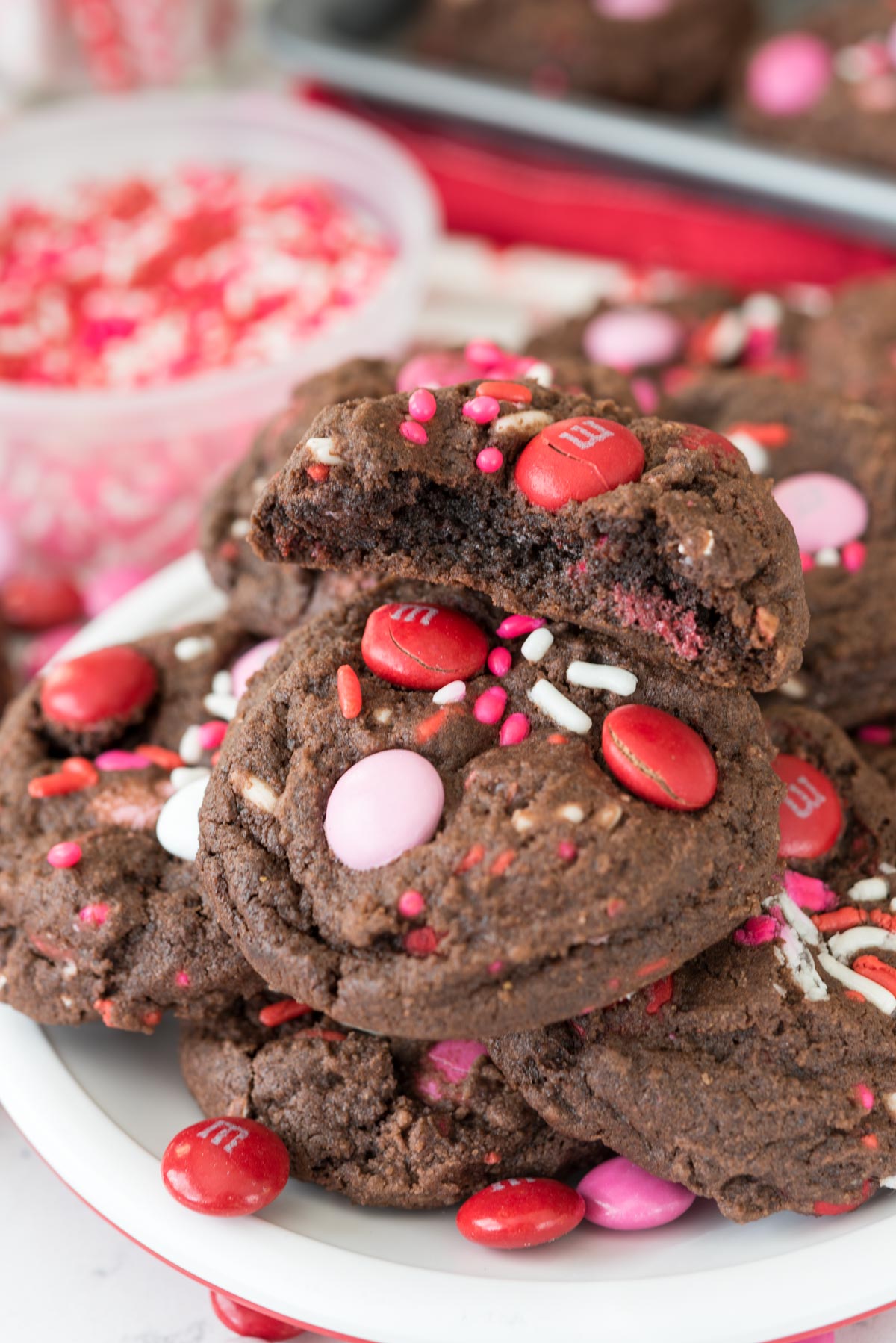 Very Valentine Pudding Cookies stacked on a plate with top one split in half to show inside of cookie