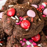 Very Valentine Pudding Cookies stacked on a plate surrounded by valentines decorations with recipe title on top of image