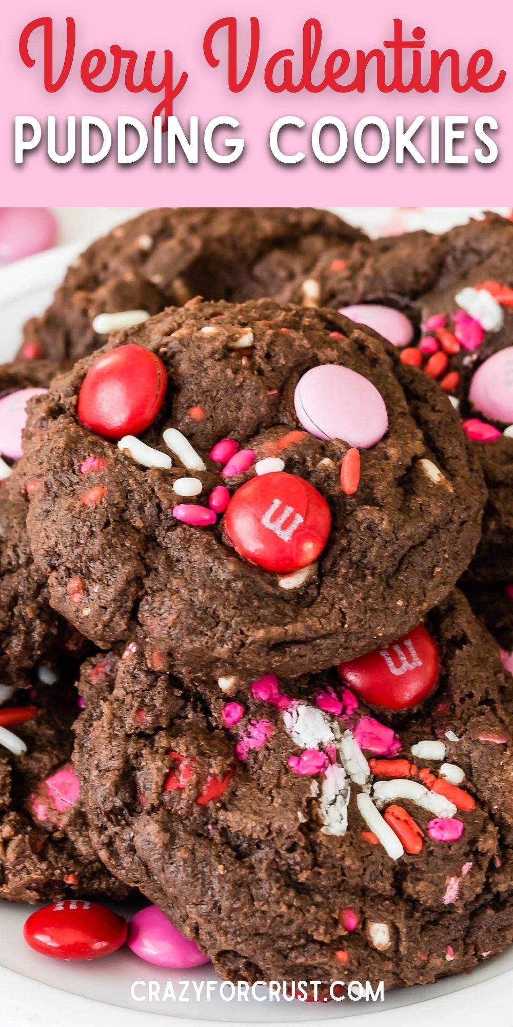 Very Valentine Pudding Cookies stacked on a plate surrounded by valentines decorations with recipe title on top of image