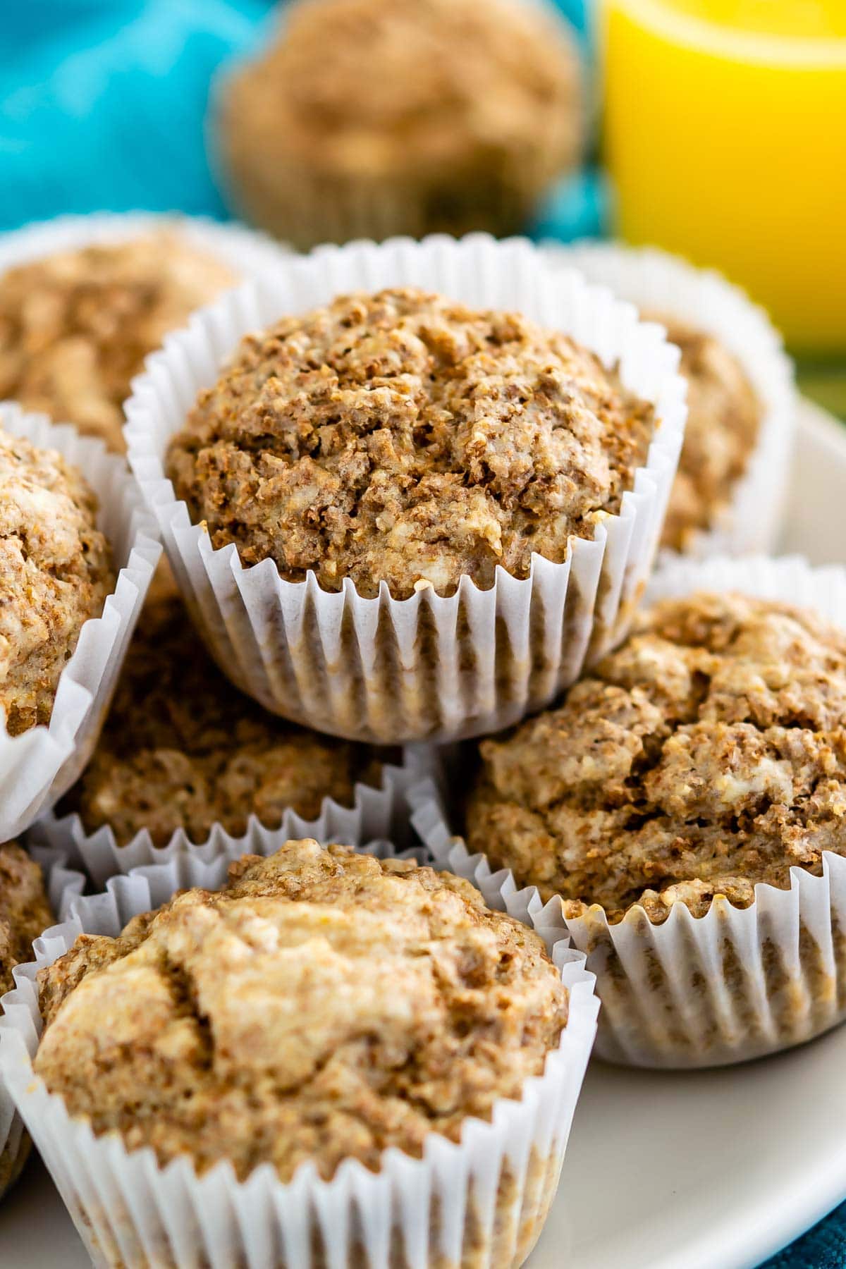 Bran muffins stacked on top of one another on a plate