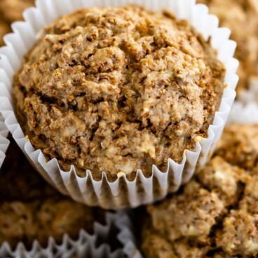 Overhead shot of Bran muffins stacked on top of one another on a plate and recipe title on top of image