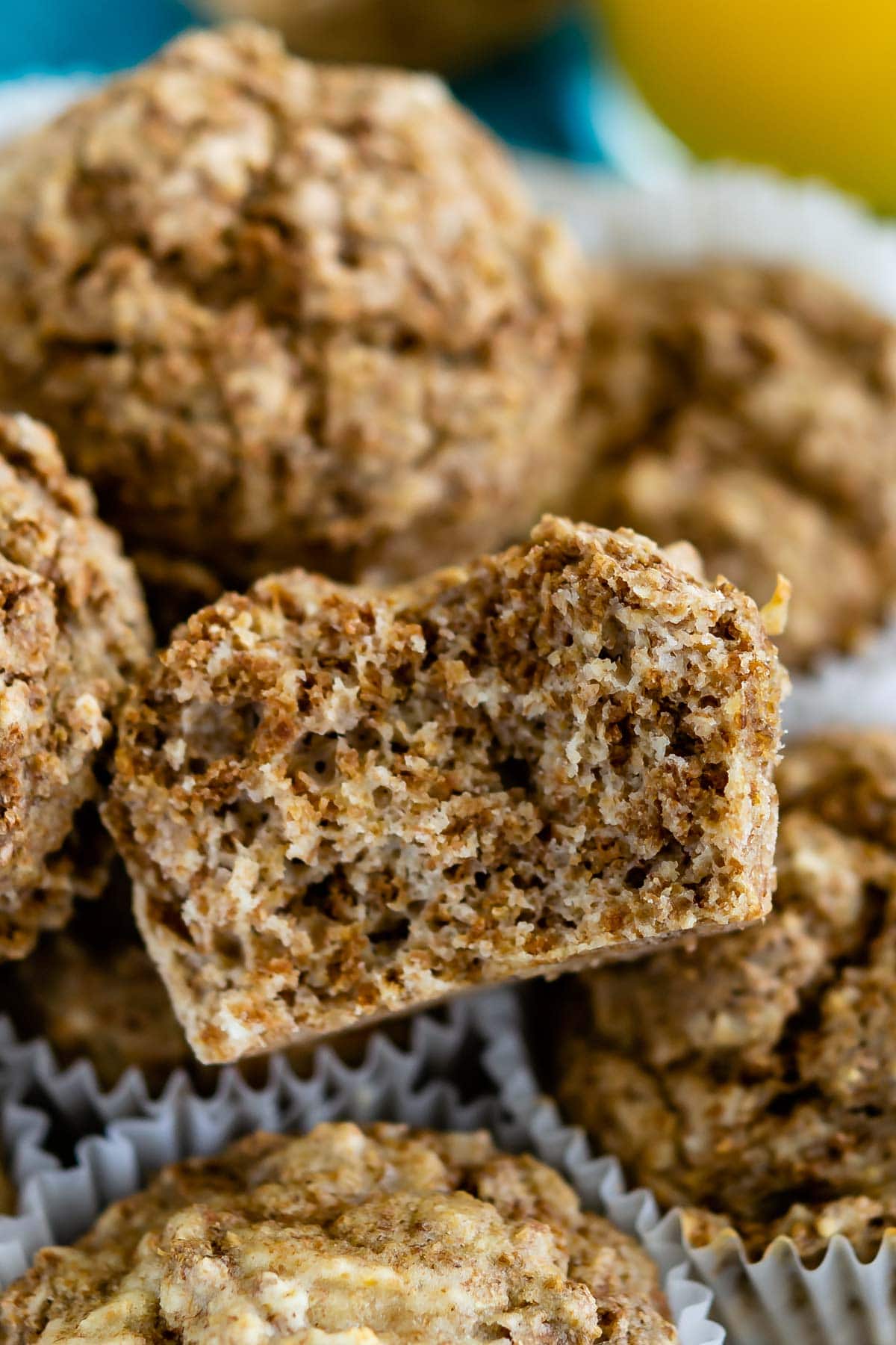 Close up shot of one bran muffin split in half to show inside with more behind it