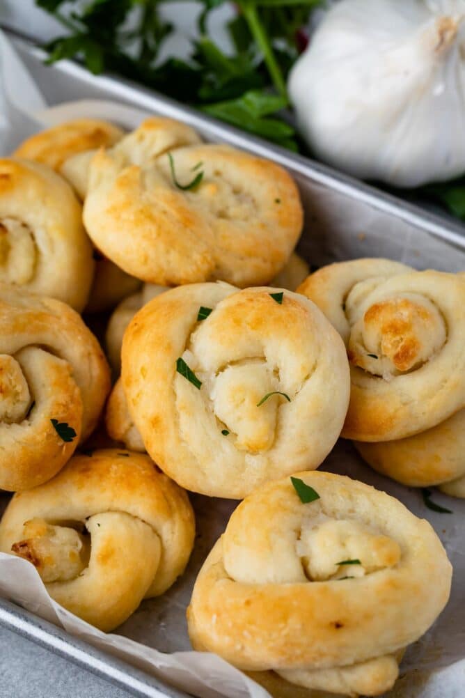 Garlic knots all together with ingredients in the background