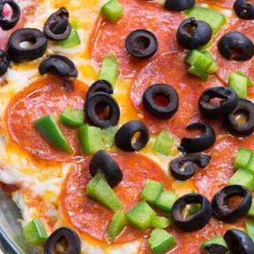 Overhead shot of 7 layer pizza dip with recipe title on top of image