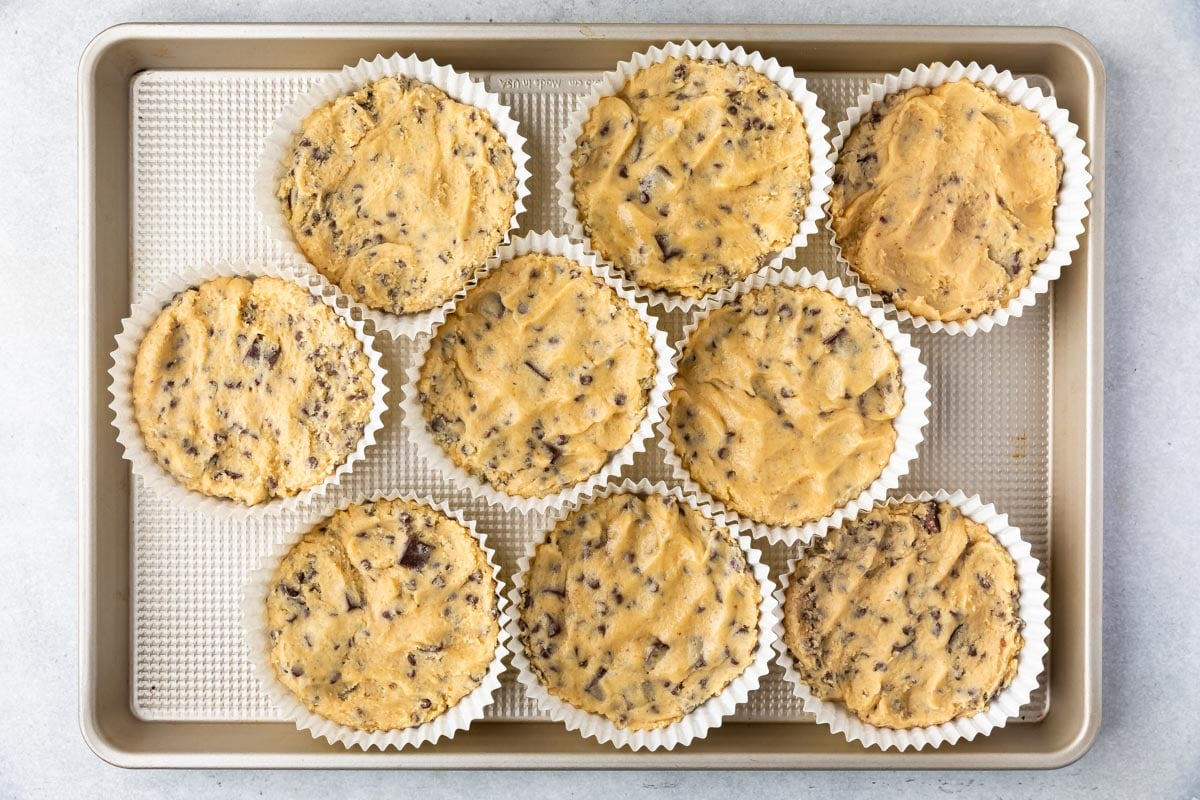 Overhead shot of num num cookie dough pressed in cookie cups on cookie sheet