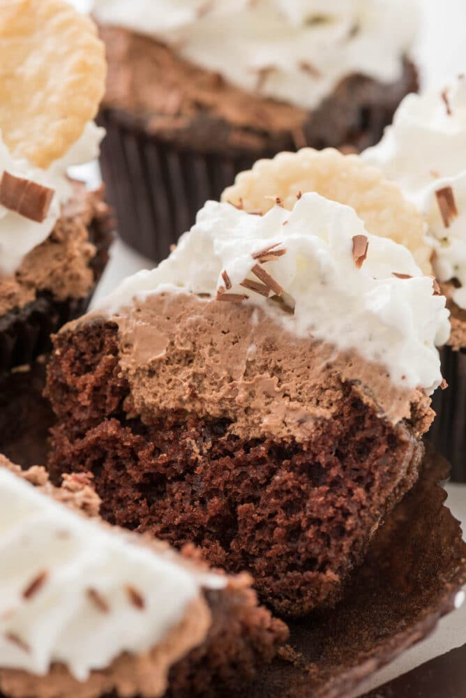 Close up shot of a french silk cupcake split in half to show inside filling