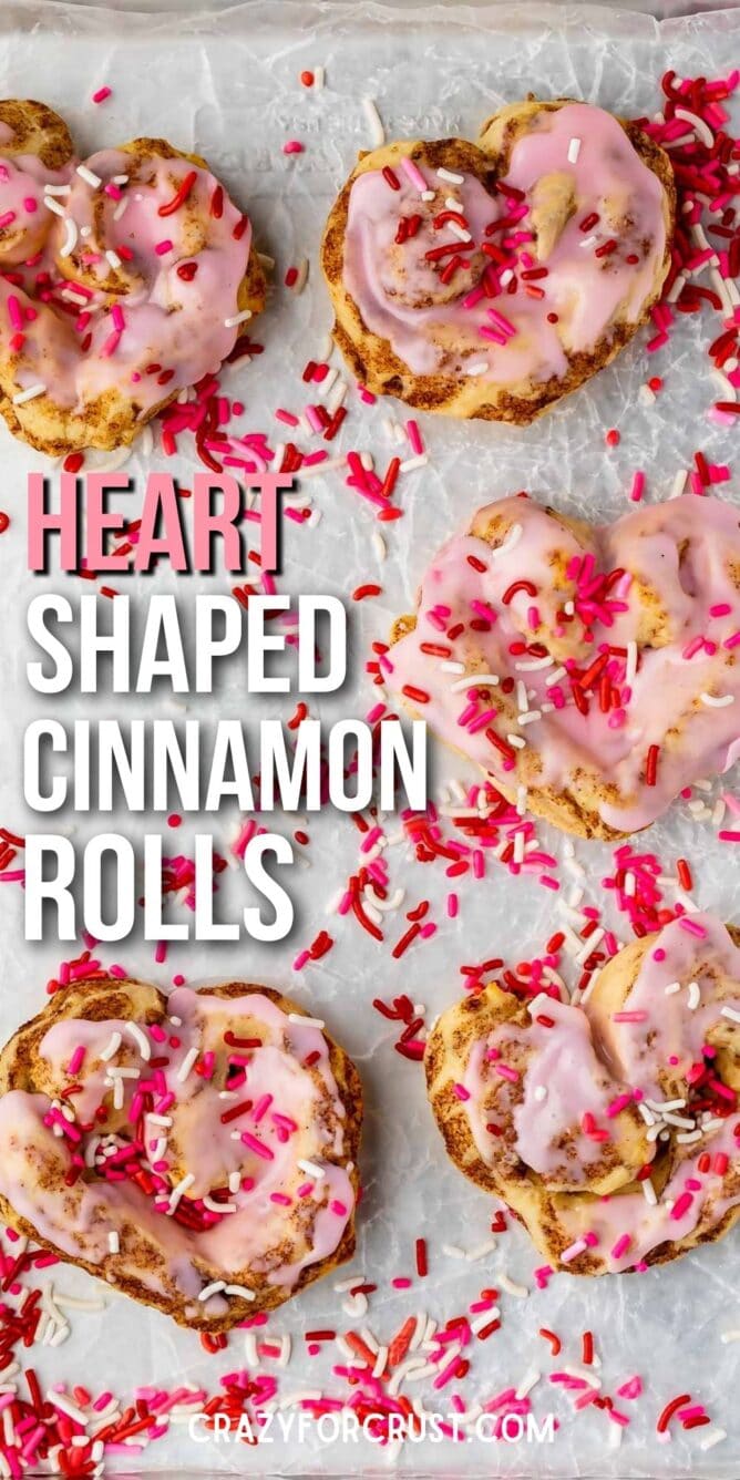 heart shaped cinnamon roll with pink icing and sprinkles